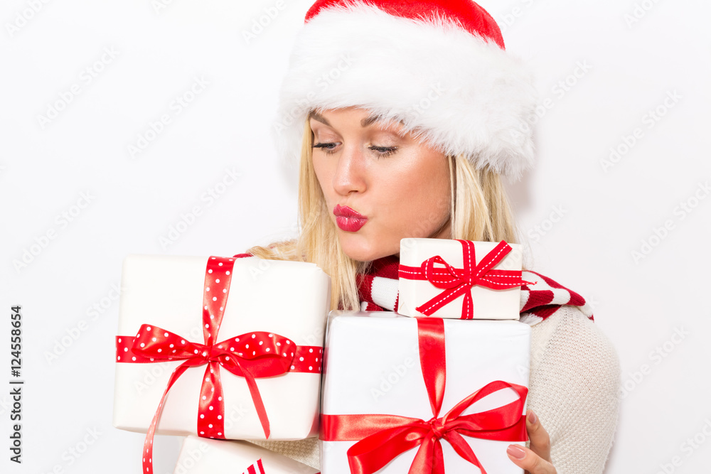 Woman with santa hat holding gift boxes Woman with santa hat holding gift boxes