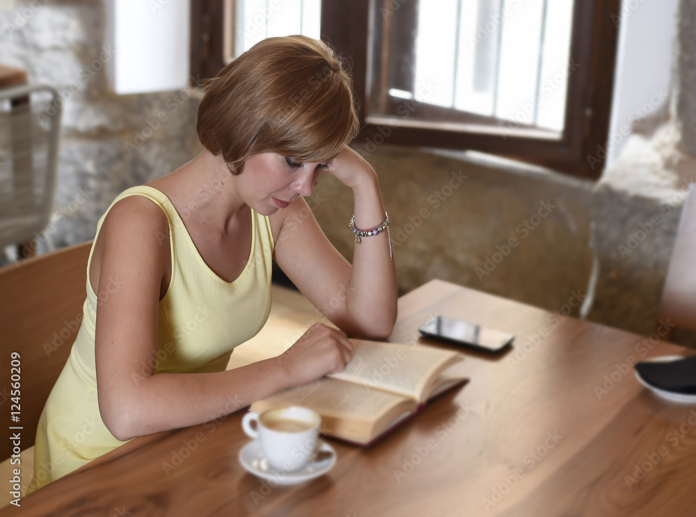 pretty woman enjoying reading book at coffee shop drinking cup of coffee or tea smiling happy pretty woman enjoying reading book at coffee shop drinking cup of coffee or tea smiling happy