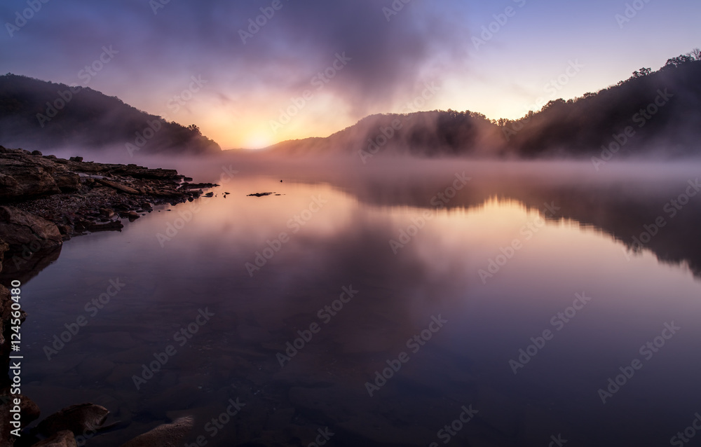 morning sunrise on foggy lake