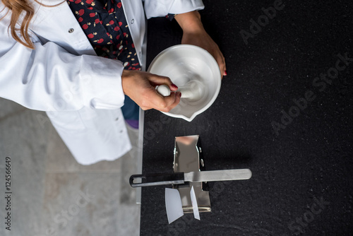 Pharmacist manufactures ointment in a pharmacy photo