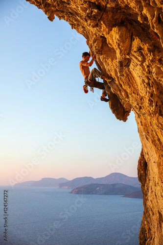 Rock climber on overhanging cliff. Kalymnos Island, Greece.