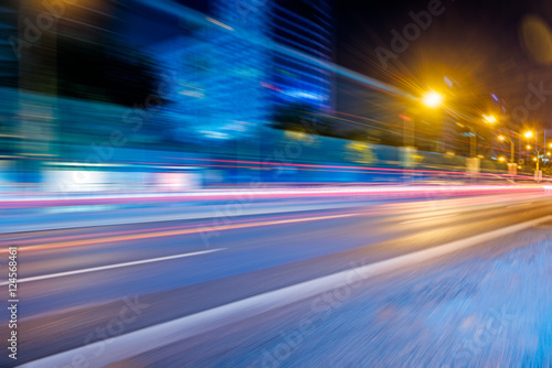 blurred traffic light trails on road at night in China. © fanjianhua