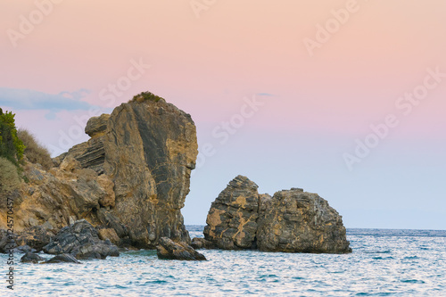 Erotospilia beach in Greece at Porto Rafti against a colorful background of the sunset. 