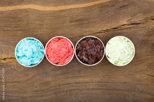 Bluleberry, strawberry, chocolate and creamy ice-cream in a row.