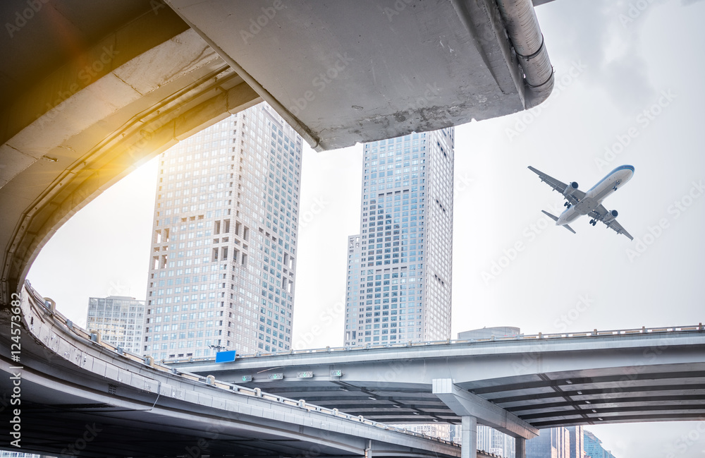 blurred street scene in city with a plane flying over in city of China. blurred street scene in city with a plane flying over in city of China.