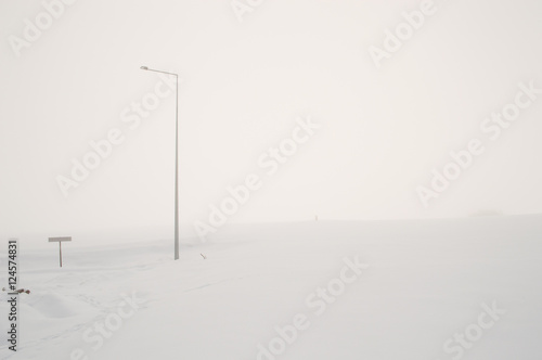 Street Lamp on a Foggy and Snowy Hill