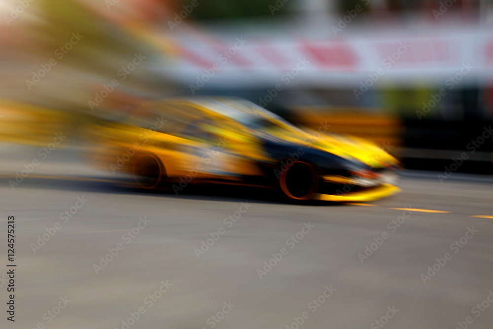 Race car racing on speed track with motion blur Race car racing on speed track with motion blur
