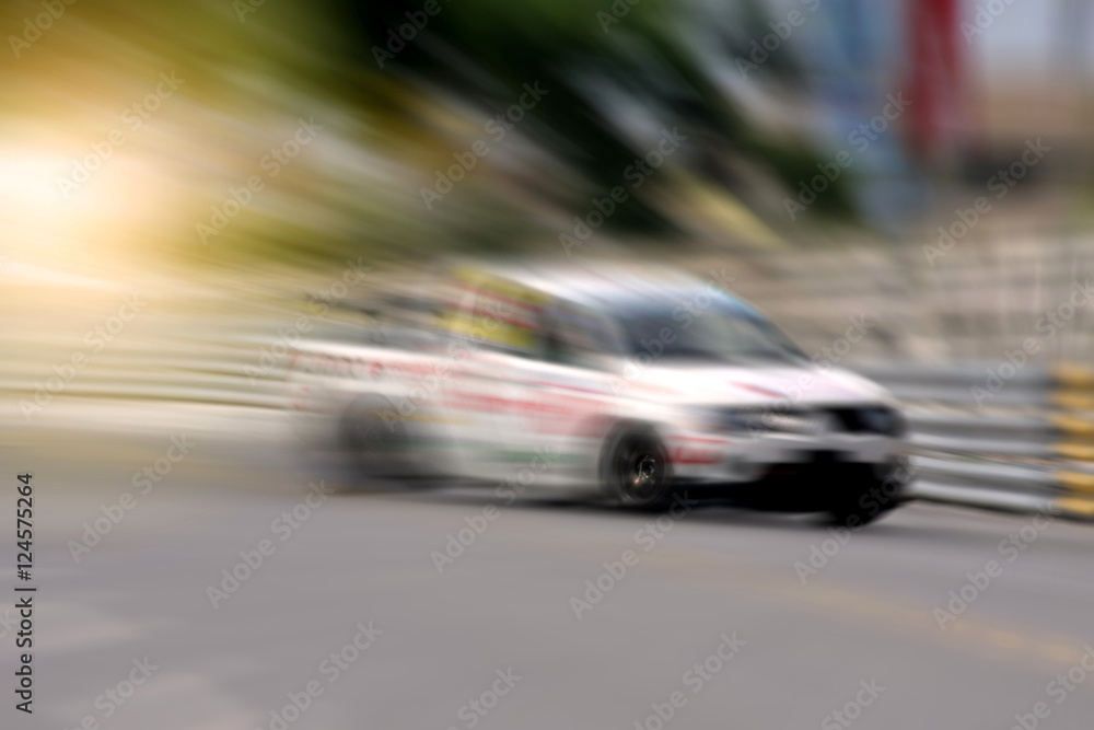 Race car racing on speed track with motion blur Race car racing on speed track with motion blur