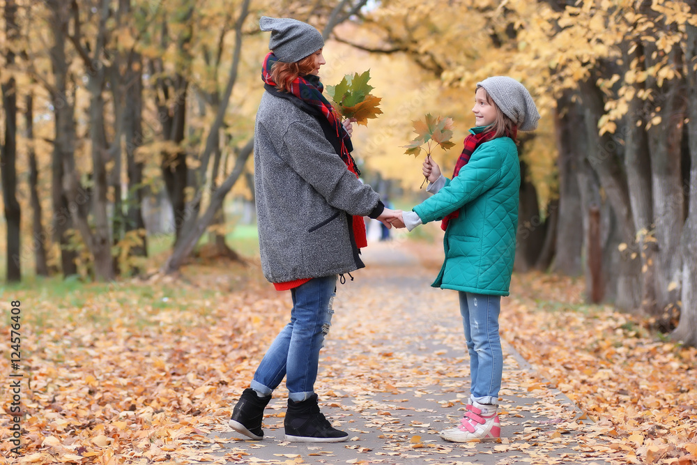 Fototapeta premium family woman and daughter walk autumn park