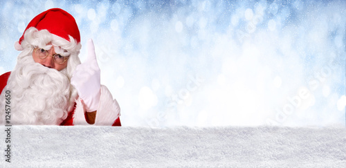 Nikolaus droht mit dem Finger vor blauem, winterlichem Hintergrund © grafikplusfoto