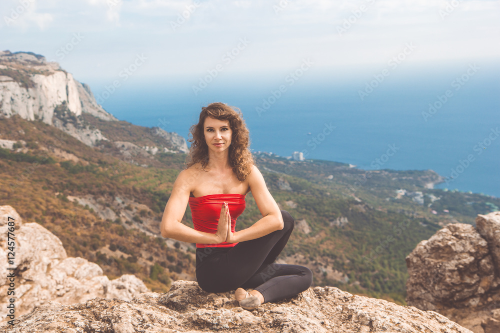 Slim woman doing yoga in mountains landscape