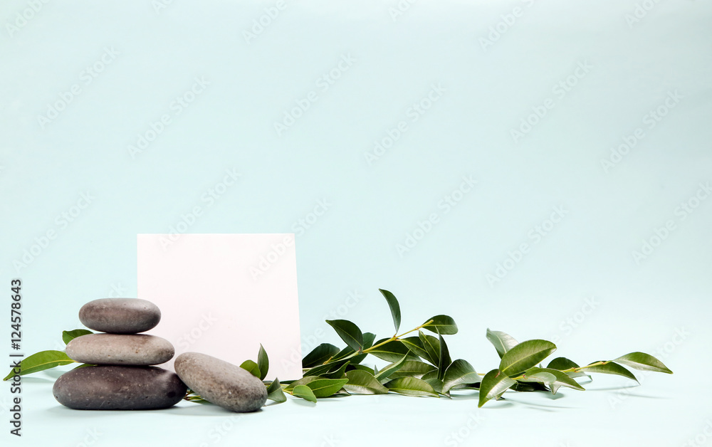 Blank paper surrounded by balanced spa stones Blank paper surrounded by balanced spa stones