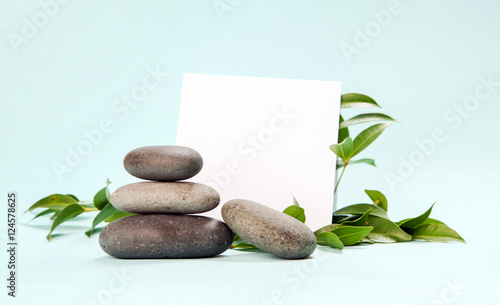 Photography Blank paper surrounded by balanced spa stones