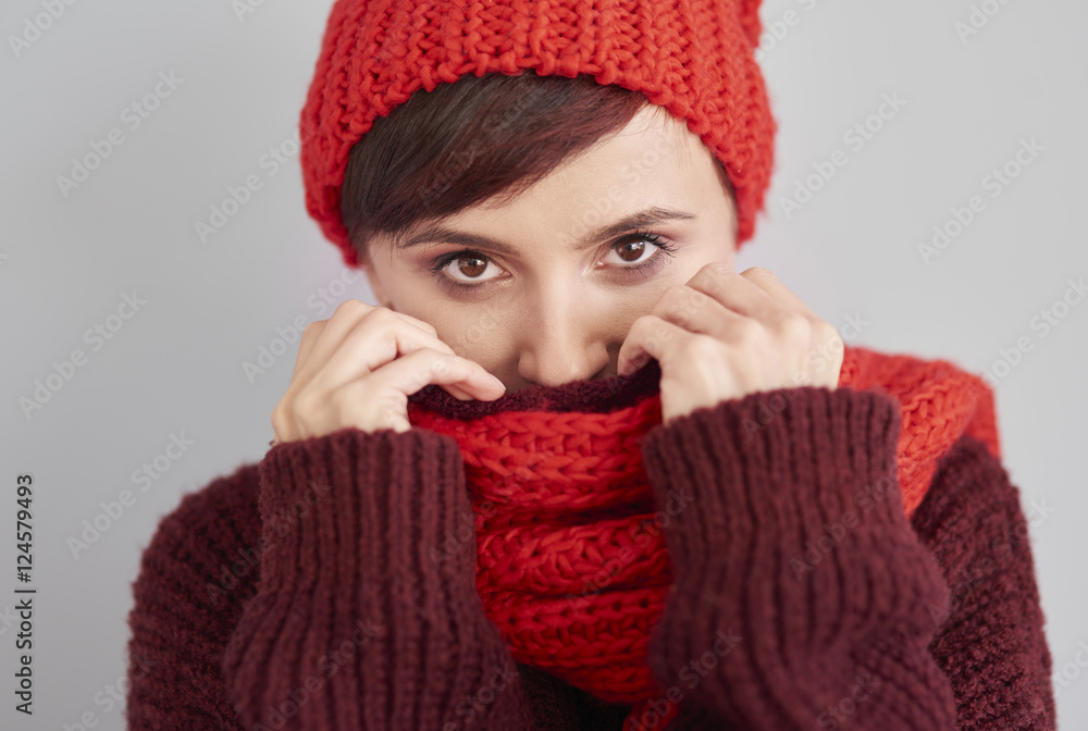 Woman hiding in warm clothes