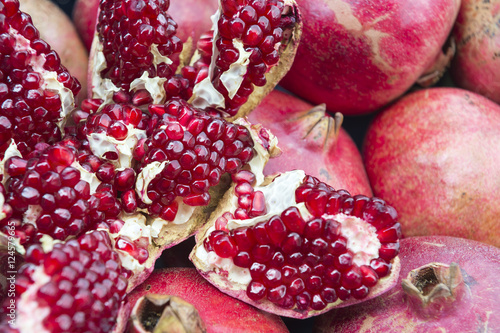 Fresh pomegranate split open to reveal the seeds on display at a Turkish juice stand 