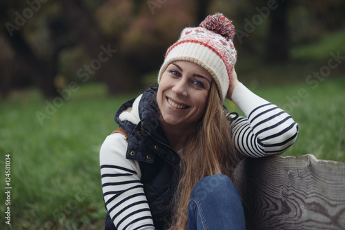 Young woman lying on park bench