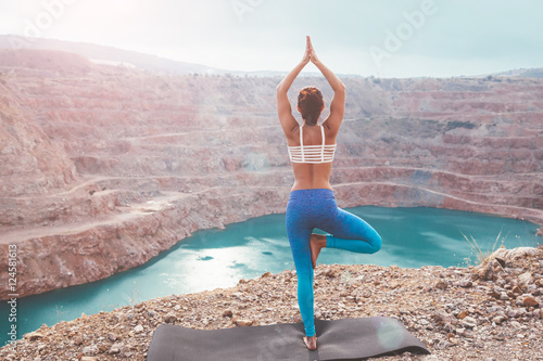 Girl training yoga pose outdoor photo