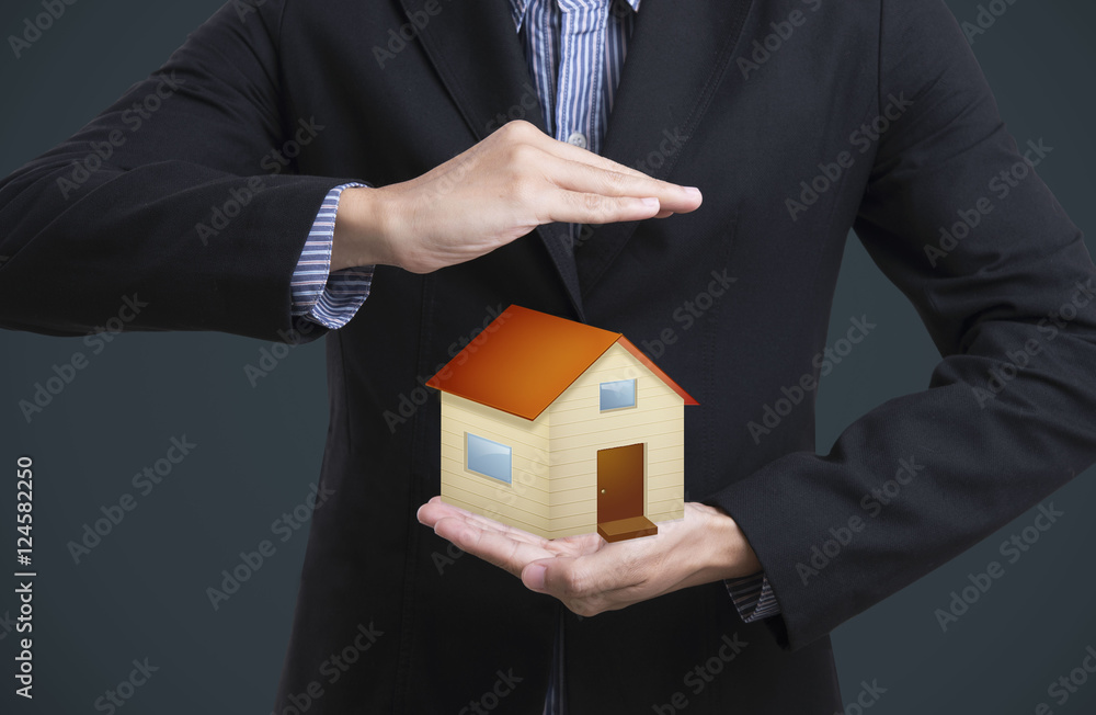 business salesman hand holding protection home concept home insurance. business salesman hand holding protection home concept home insurance.