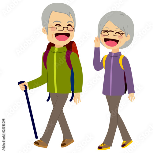 Lovely senior couple laughing and talking walking wearing climbing clothing and equipment