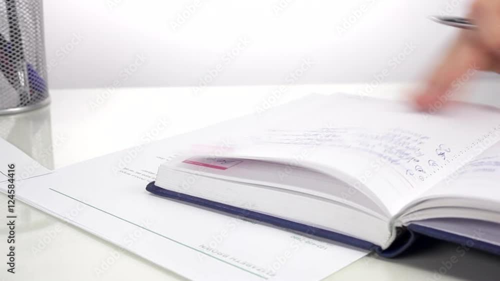 Businessman Makes a Plan/Businessman making notes in a diary. Close up Businessman Makes a Plan/Businessman making notes in a diary. Close up