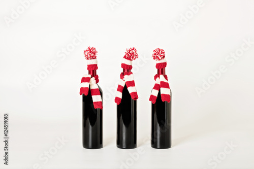 Merry Christmas and happy New year. Three bottles of wine in kni photo