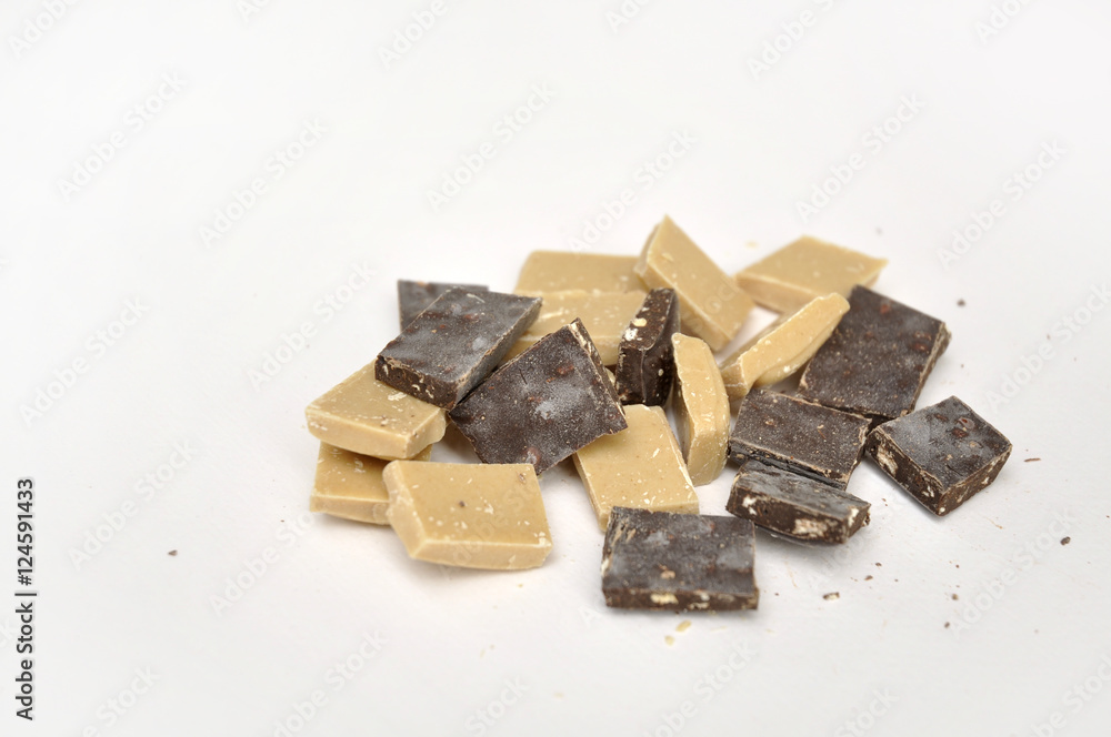 dark and white chocolate pieces on white background dark and white chocolate pieces on white background