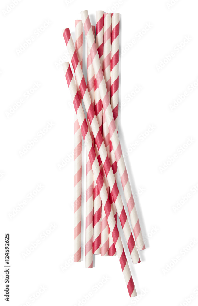 Obraz premium A pile of red and pink striped paper drinking straws isolated on a white background