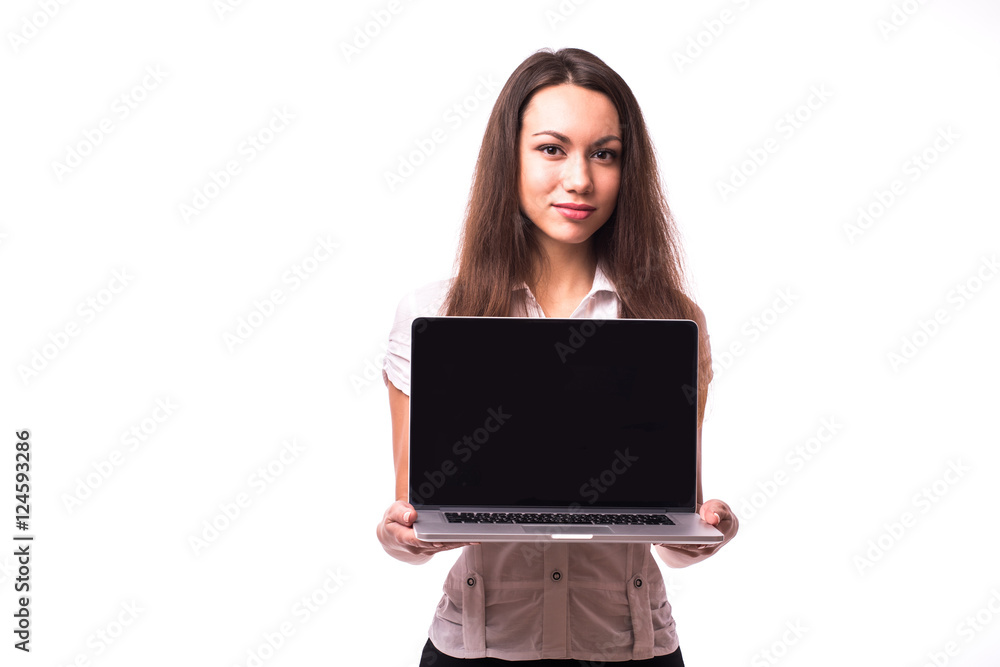 Smiling pretty young woman with friendly happy smile holding a laptop computer and pointing at screen where you add your marketing message Smiling pretty young woman with friendly happy smile holding a laptop computer and pointing at screen where you add your marketing message