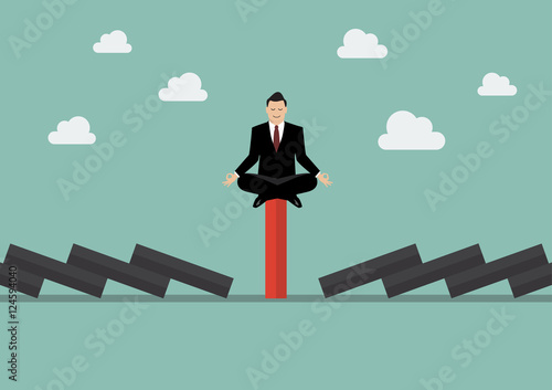 Businessman meditating on unique red domino tile among falling b