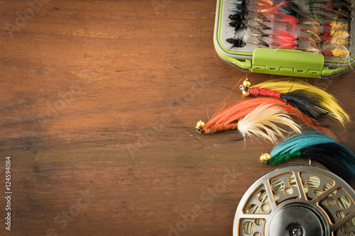 Fly fishing gear, which includes a reel and containers of flies with copy space