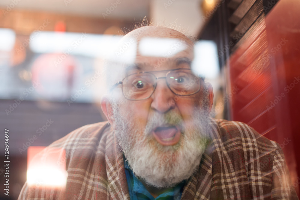 old man making funny face through window Stock Photo | Adobe Stock