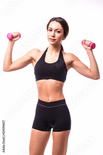 Young woman is exercising with dumbbells