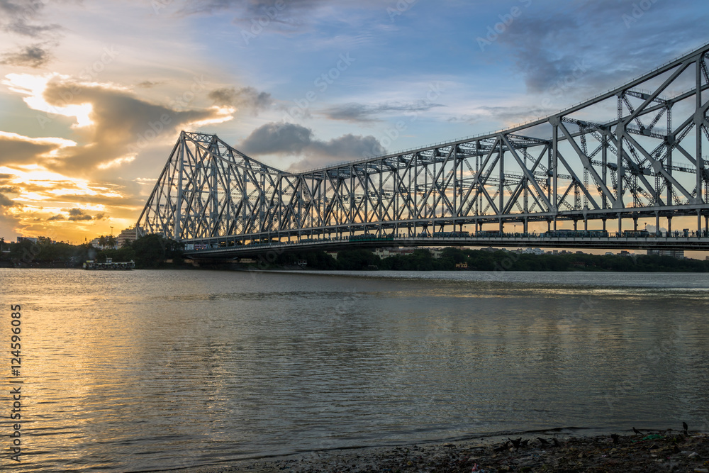 Howrah Bridge on river Hooghly at sunset. Howrah Bridge is a cantilever ...