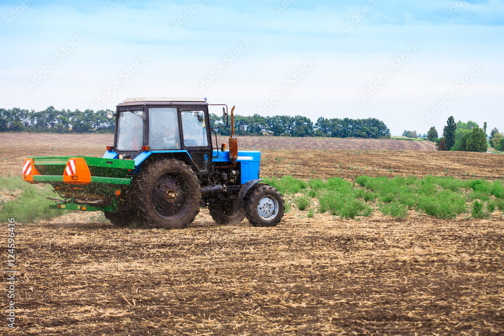 Rural landscape with old tractor in a field sow seed. Rural landscape with old tractor in a field sow seed.