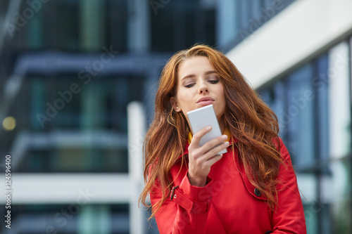Wallpaper Mural Portrait of young brunette woman in beige coat talking on the ph Torontodigital.ca