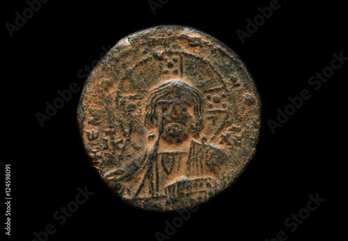 Photos Ancient copper coin with saint portrait on it