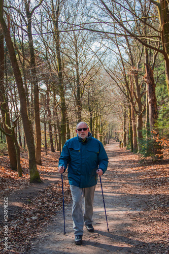 Senior at the Nordic walking in landscape of autumn forest © Sinica Kover