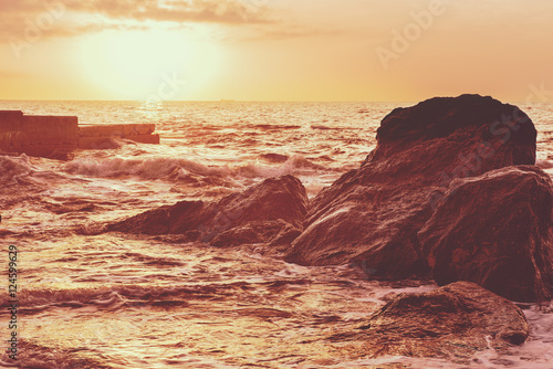 Sea wave splashing on rocks  natural holiday sunny vintage hipster seasonal background