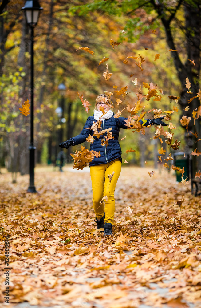 Middle-aged woman walking in city park Middle-aged woman walking in city park