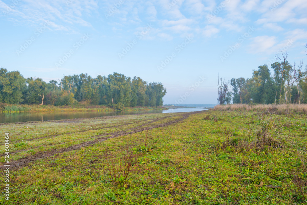 Shore of a lake at sunrise in autumn Shore of a lake at sunrise in autumn