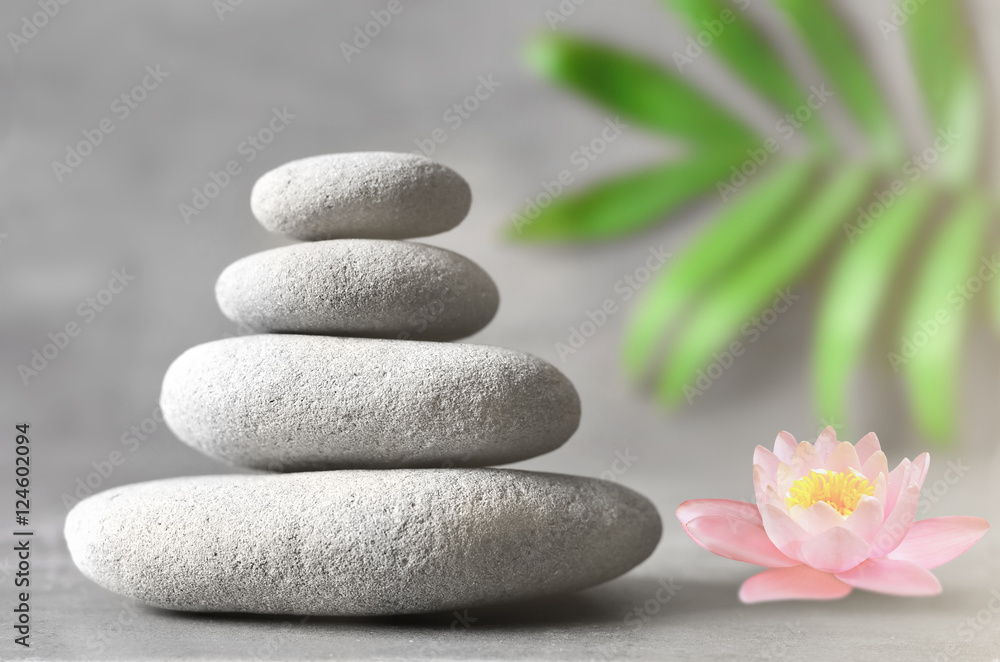 Spa stones with flower lily on light background Spa stones with flower lily on light background