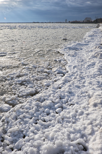 Lumps of snow and ice frazil on the surface of the freezing rive