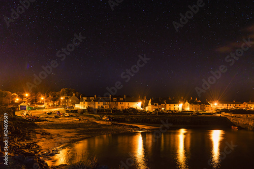 Craster Village at Night under a starry sky on Northumberland Coast  with a hint of the Northern Lights  