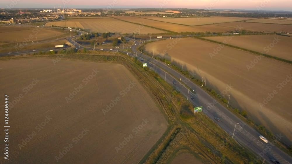 Busy road approaching highway junction roundabout, aerial view Busy road approaching highway junction roundabout, aerial view