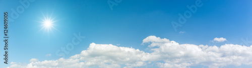 Panorama blue sky with clouds and sun reflection