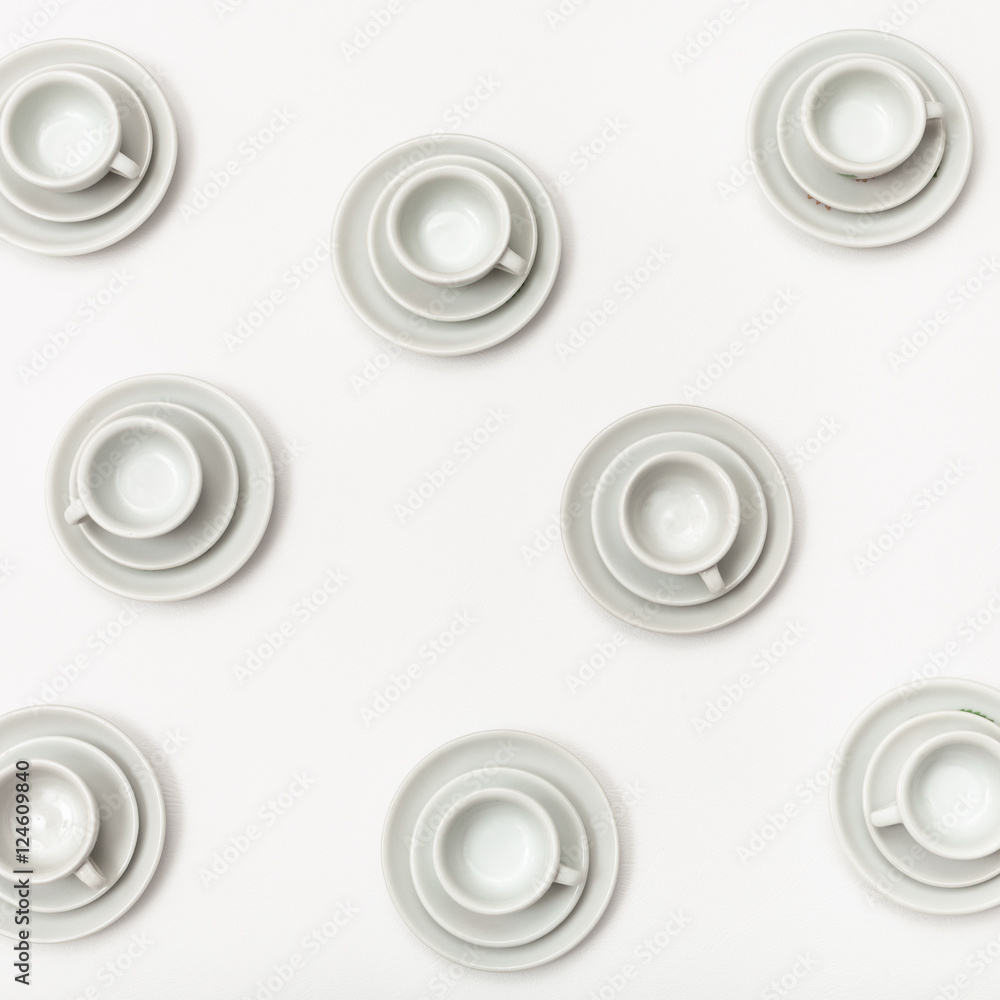 top view several white cups and saucers on white top view several white cups and saucers on white