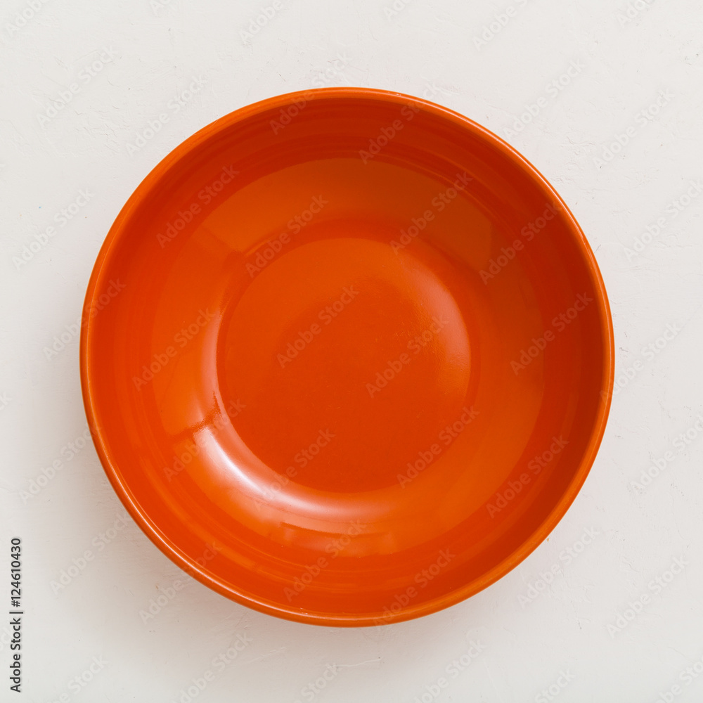 above view of orange bowl on plastering plate above view of orange bowl on plastering plate