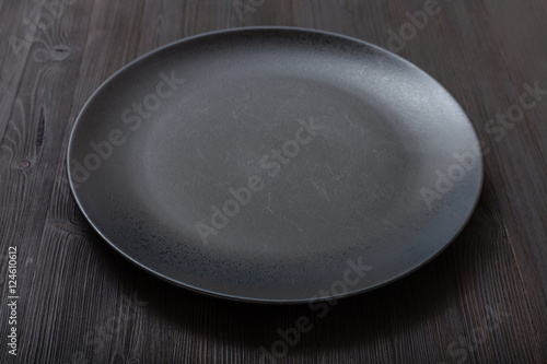 black plate on dark brown table
