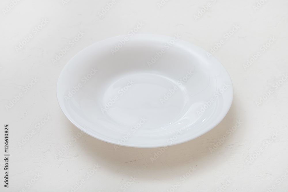 one white deep plate on plastering board one white deep plate on plastering board