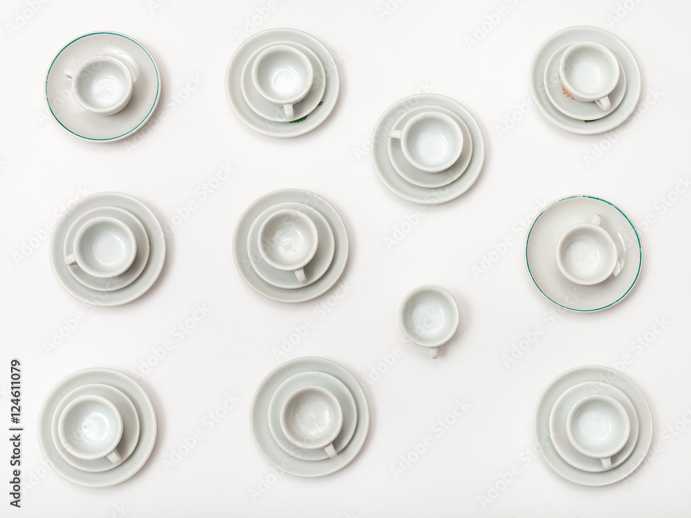 top view of many white cups and saucers on white top view of many white cups and saucers on white